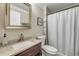 Traditional bathroom featuring granite countertops and a shower with curtain at 402 N Orange St, New Smyrna Beach, FL 32168