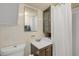 Bathroom featuring vanity, shower, mirror, cabinet, and toilet at 402 N Orange St, New Smyrna Beach, FL 32168