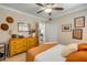 Bedroom with stylish decor and ample natural light, dresser, and view into the kitchen at 402 N Orange St, New Smyrna Beach, FL 32168