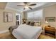 A cozy bedroom with carpet and a ceiling fan at 402 N Orange St, New Smyrna Beach, FL 32168