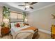Comfortable bedroom featuring natural light, decorative curtains, and a stylish ceiling fan at 402 N Orange St, New Smyrna Beach, FL 32168