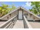 Exterior view of a charming home with a long wooden walkway and appealing architecture at 402 N Orange St, New Smyrna Beach, FL 32168