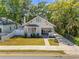 Charming bungalow with well-maintained lawn, inviting front porch, and neutral exterior paint at 402 N Orange St, New Smyrna Beach, FL 32168