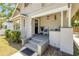 Inviting front porch with rocking chairs, classic lighting, and a charming entryway at 402 N Orange St, New Smyrna Beach, FL 32168