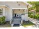 Inviting front porch with rocking chairs, classic lighting, and a charming entryway at 402 N Orange St, New Smyrna Beach, FL 32168