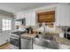Well-equipped kitchen with stainless steel appliances and a farmhouse sink at 402 N Orange St, New Smyrna Beach, FL 32168