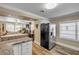 Modern kitchen with stainless appliances, a breakfast bar, and an open layout into the living area at 402 N Orange St, New Smyrna Beach, FL 32168