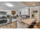 Bright kitchen with stainless appliances, granite countertops, and a breakfast bar at 402 N Orange St, New Smyrna Beach, FL 32168
