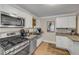 Charming kitchen featuring stainless steel appliances and granite counters at 402 N Orange St, New Smyrna Beach, FL 32168