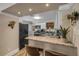 This home offers a cozy kitchen, granite countertops, stainless steel appliances, and a breakfast bar at 402 N Orange St, New Smyrna Beach, FL 32168
