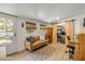 This light-filled living room with wood-look floors leads to a washer/dryer at 402 N Orange St, New Smyrna Beach, FL 32168