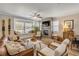 Cozy living room with a fireplace, plenty of seating, and a large bay window at 402 N Orange St, New Smyrna Beach, FL 32168