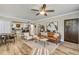 Open-concept living room with modern decor connecting to a dining area and kitchen at 402 N Orange St, New Smyrna Beach, FL 32168