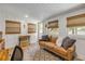 Bright living room featuring wood-look floors, board and batten walls, and natural light from multiple windows at 402 N Orange St, New Smyrna Beach, FL 32168