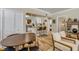 Interior view of a living space that flows into the dining and kitchen area, all with wood flooring at 402 N Orange St, New Smyrna Beach, FL 32168