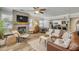 Bright living room with a decorative fireplace, wood floors, and modern furniture at 402 N Orange St, New Smyrna Beach, FL 32168