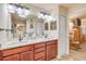 Bathroom showcasing a double vanity with marble countertops, decorative accents, and a view into the bedroom at 406 Phillips Creek Ln, New Smyrna Beach, FL 32168