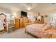 Cozy bedroom featuring warm wood furniture, a shell patterned bedspread, and bright, natural light at 406 Phillips Creek Ln, New Smyrna Beach, FL 32168