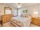 Bright bedroom featuring a dresser with a mirror and nautical-themed decor, creating a relaxing atmosphere at 406 Phillips Creek Ln, New Smyrna Beach, FL 32168