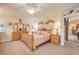 Comfortable bedroom with wooden furniture, light-colored walls, and a doorway leading to the living area at 406 Phillips Creek Ln, New Smyrna Beach, FL 32168