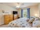 Bedroom with coastal decor, a large window for natural light, and warm wood accents creating a relaxing atmosphere at 406 Phillips Creek Ln, New Smyrna Beach, FL 32168