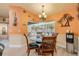 Dining area with a glass table, pool views, and beach-themed decor, creating a relaxing and inviting space at 406 Phillips Creek Ln, New Smyrna Beach, FL 32168