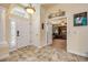 Inviting entryway features a decorative front door, elegant chandelier, and beautiful tile flooring at 406 Phillips Creek Ln, New Smyrna Beach, FL 32168