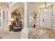 Elegant foyer with tiled flooring, decorative columns, and views into the living area at 406 Phillips Creek Ln, New Smyrna Beach, FL 32168