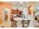 Kitchen with breakfast bar, pendant lighting, stainless appliances and adjoining breakfast nook at 406 Phillips Creek Ln, New Smyrna Beach, FL 32168