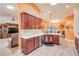 Charming kitchen boasts warm cabinets, granite counters, stainless appliances and eat in area at 406 Phillips Creek Ln, New Smyrna Beach, FL 32168