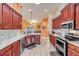 Bright kitchen with wooden cabinets, white countertops, and stainless steel appliances at 406 Phillips Creek Ln, New Smyrna Beach, FL 32168