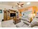 Inviting living room with plush sofas, a decorative ceiling fan, and views of the lanai at 406 Phillips Creek Ln, New Smyrna Beach, FL 32168