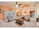 Cozy living room featuring comfortable seating, a ceiling fan, and sliding glass doors to the lanai at 406 Phillips Creek Ln, New Smyrna Beach, FL 32168