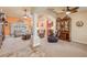 Bright and airy living room featuring stylish furniture, an entertainment center, and a seamless flow into the kitchen at 406 Phillips Creek Ln, New Smyrna Beach, FL 32168