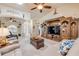 Open-concept living room with stylish furniture, large entertainment center, and plenty of natural light at 406 Phillips Creek Ln, New Smyrna Beach, FL 32168