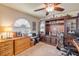 Comfortable office with custom built-in shelving, ceiling fan, and great lighting at 406 Phillips Creek Ln, New Smyrna Beach, FL 32168