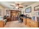 Spacious home office with custom built-ins, ceiling fan, and natural light at 406 Phillips Creek Ln, New Smyrna Beach, FL 32168