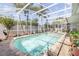 Enclosed pool area with a brick patio, palm trees, and lounge chairs, perfect for relaxation at 406 Phillips Creek Ln, New Smyrna Beach, FL 32168