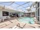 Spacious outdoor pool area with multiple seating areas and well-maintained landscaping for relaxation and entertainment at 406 Phillips Creek Ln, New Smyrna Beach, FL 32168
