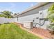 Well-maintained yard featuring a GENERAC generator and a white vinyl fence for added privacy and security at 406 Phillips Creek Ln, New Smyrna Beach, FL 32168