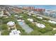 Aerial view of property showing pool, tennis court, mature trees and proximity to beach and coastal highway at 4150 S Atlantic Ave # 111B, New Smyrna Beach, FL 32169