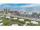 A beautiful coastal aerial view with condos, beach and nearby property surrounded by mature trees at 4150 S Atlantic Ave # 111B, New Smyrna Beach, FL 32169