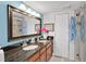 This bright bathroom features a double vanity, a large mirror, and a glass-enclosed shower at 4150 S Atlantic Ave # 111B, New Smyrna Beach, FL 32169