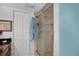 Bathroom featuring tiled shower with glass door, closet, and blue towel at 4150 S Atlantic Ave # 111B, New Smyrna Beach, FL 32169