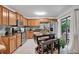 Well-equipped kitchen featuring stainless steel appliances, granite countertops, wooden cabinetry, and a view of the outside at 4150 S Atlantic Ave # 111B, New Smyrna Beach, FL 32169