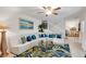 Stylish living room showcasing a large sectional sofa, decorative pillows, a unique rug, and a staircase at 4150 S Atlantic Ave # 111B, New Smyrna Beach, FL 32169