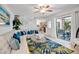 Bright living room with staircase, sliding doors, and a view of the outdoor patio at 4150 S Atlantic Ave # 111B, New Smyrna Beach, FL 32169
