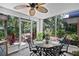 Enclosed patio with outdoor table and chairs, overlooking beautiful greenery at 4150 S Atlantic Ave # 111B, New Smyrna Beach, FL 32169