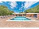 Exterior view of a community pool surrounded by brick pavers and ample seating, perfect for relaxing in the sun at 4150 S Atlantic Ave # 111B, New Smyrna Beach, FL 32169