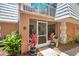 Close-up of the front entrance with potted plants, screened-in porch, and balcony above at 4150 S Atlantic Ave # 111B, New Smyrna Beach, FL 32169